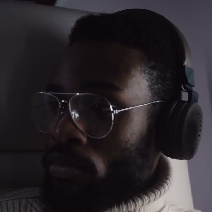 A man in headphones, listening.